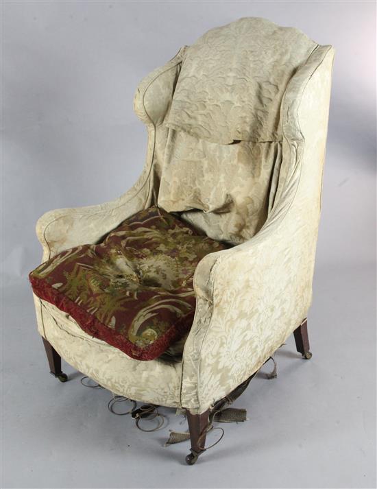A late 19th century mahogany wing armchair